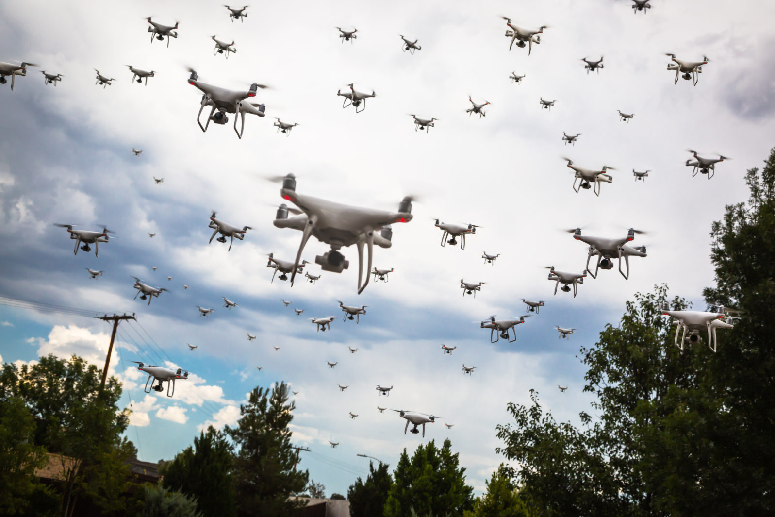 dozens of drones swarm in the cloudy sky stockpack adobe stock 1597x1065 1